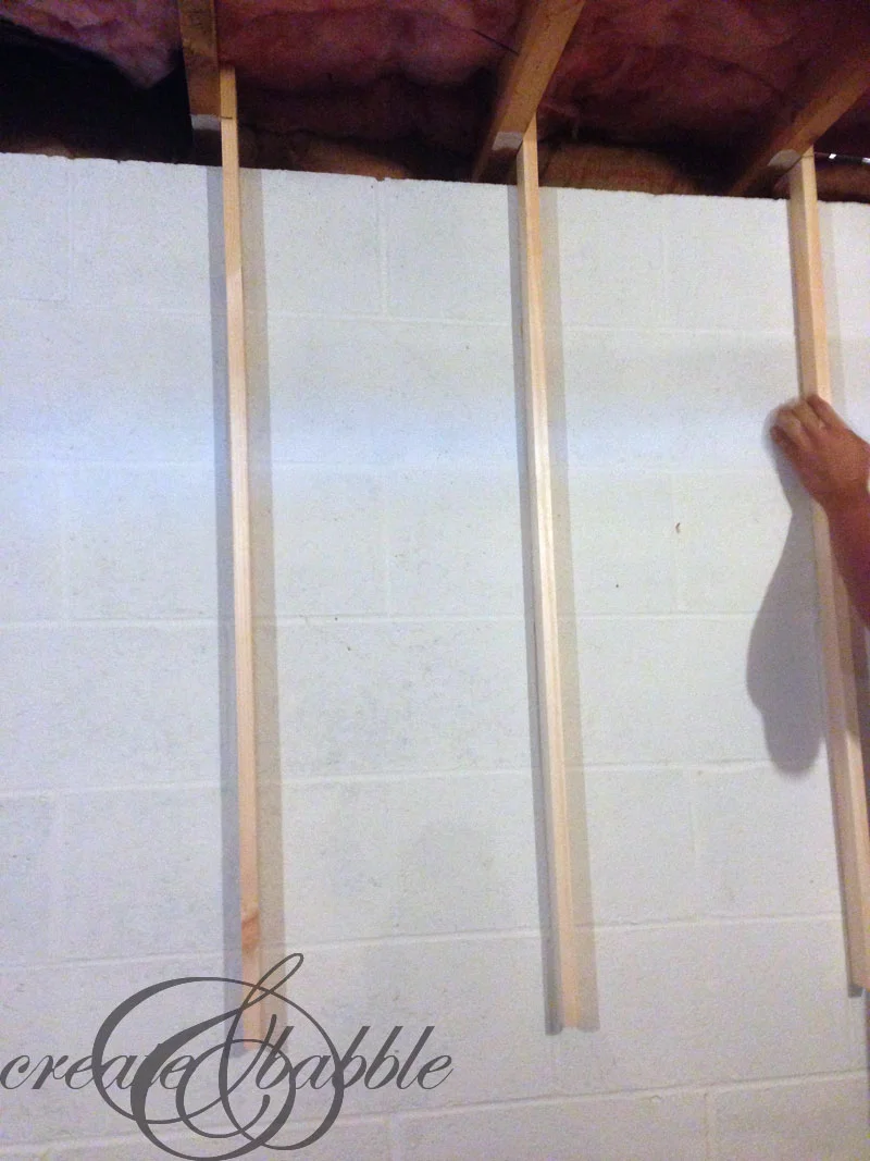 Attaching a pegboard to cement block walls without screwing into blocks
